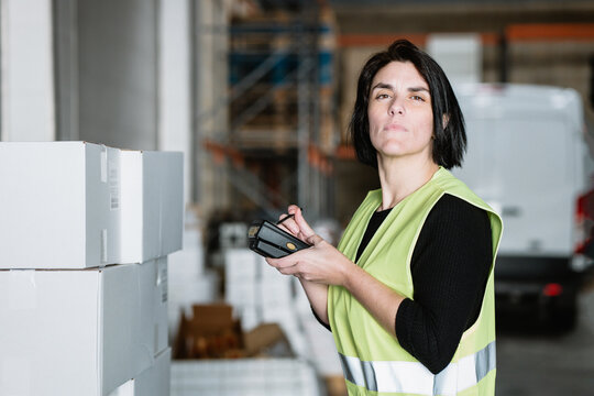 Woman with data terminal checking supplies