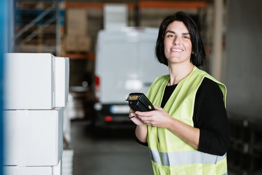 Woman with data terminal checking supplies