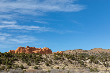 Fototapeta na wymiar Distant view to the red rocks of the Garden of the Gods in Colorado Springs, winter landscape with clear blue sky, horizontal aspect