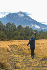 Fototapeta na wymiar Mountaineer Walking On The Mountain with view at popocatepetl volcano