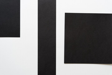 three black paper rectangles on white