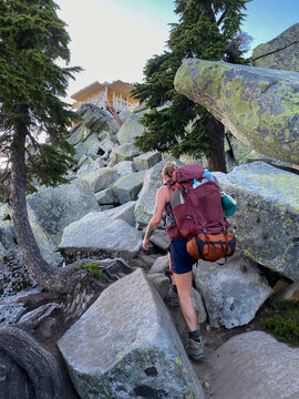 Girl climbing a boulder field up to Mount Pilchuck fire lookout
