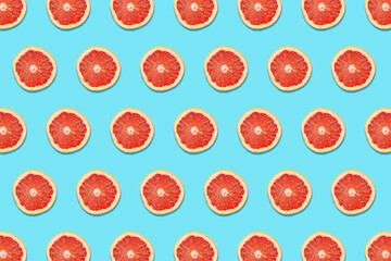Grapefruit Slices on a Blue Background in a Pattern