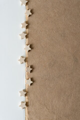 Fototapeta na wymiar small wooden stars on paper