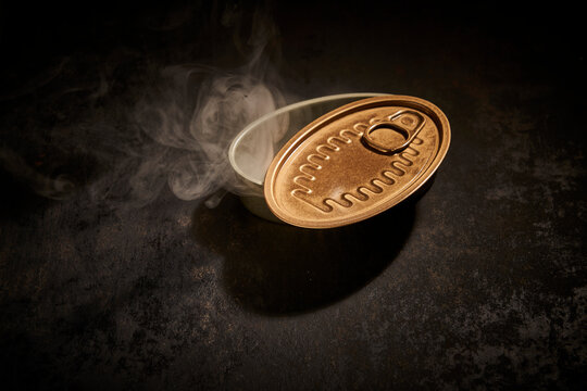 Opened tin can with smoke