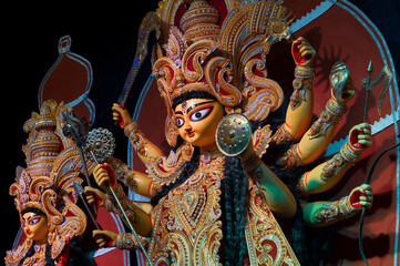 Goddess Durga idol , Durga Puja festival at night. Shot under colored light at Howrah, West Bengal, India. Biggest festival of Hinduism , celebrated all over the world.