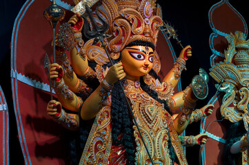 Decorated Durga Puja pandal with Durga idol, Durga Puja festival at night. Shot under colored light...