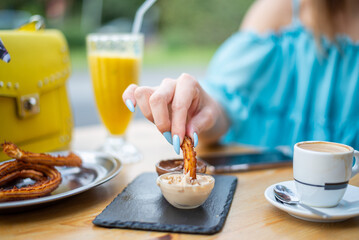 Girl enjoying churros at a cafe