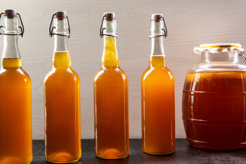 Fresh kombucha beverage in glass swing-top bottles. Healthy and refreshing fermented drink.