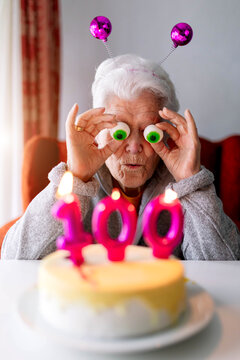 Funny elderly woman celebrating 100 birthday at home