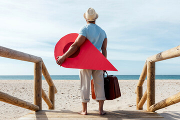 Traveling man with red map pointer on boardwalk