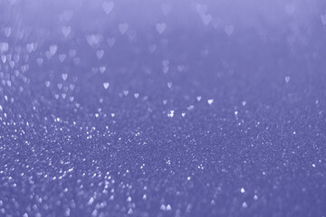 Trendy very peri color of the year 2022, violet blue hearts, sparkling glitter bokeh background, valentines day abstract defocused texture
