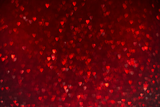 Red hearts, sparkling glitter bokeh background, valentines day abstract defocused texture