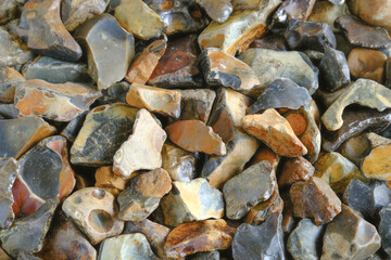 A closeup of knapped fild flint stones pebbes background.