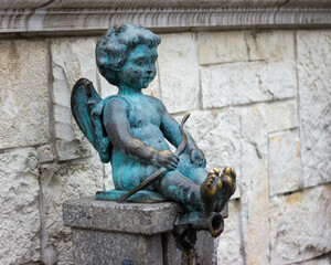 Naklejka premium Statue of cupid boy, eros fountain. Love angel sculpture