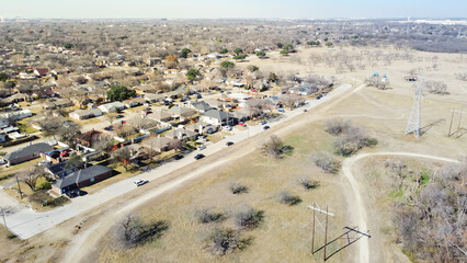 Aerial view residential neighborhood near park with power pylon transmission tower suburbs Dallas, Texas, USA