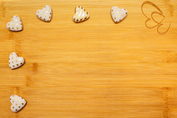 Bamboo wooden board with carved hearts, white-gold hearts and heart-shaped soap. Love valentine concept. Flat lay