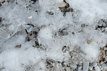 frozen beach with some pebbles visible