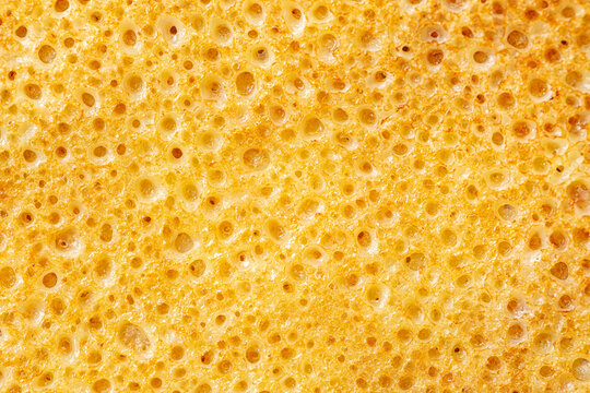 Pancake or crepe surface. Macro photo background. Bubbled Texture.