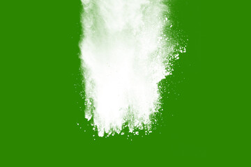 Explosion of white powder isolated on green background. Abstract colored background. holi festival.