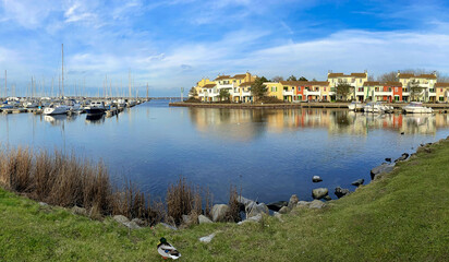 Fototapeta premium apartments at a sea harbour in the sunset