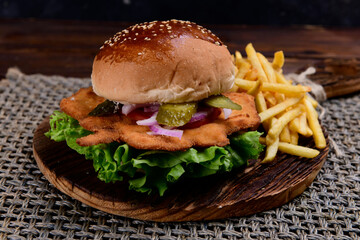 Big hamburger, French fries and vegetables