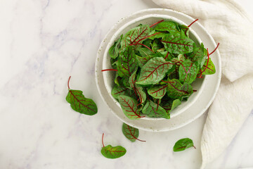 Fresh organic swiss chard leaves (mangold) on marble background. Healthy vegetables. Leaf beetroot. Selective focus, top view, copy space