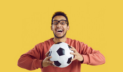 Crazy soccer fan supporting favorite team. Portrait of happy funny excited cheerful black man...