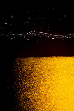 Close up of the beer,Close up in foam and bubbles of beer on black background,Water drops background 