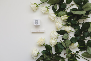 8 March, Woman Day background with white roses and place for text on white background top view