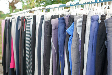 Second hand clothes and pants with quality brands imported from abroad are sold on the roadside at low prices. The clothes and pants are still in good condition and still fit to wear.