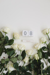 8 March, Woman Day background with white roses and place for text on white background top view
