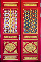 Ancient chinese red wooden door with dragon golden carve of chinese temple