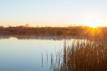 Fototapeta premium Cold autumn morning and sunrise over the lake