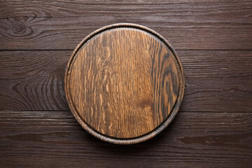 Round cutting board with groove on wooden table