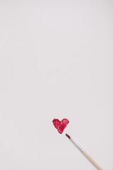 Heart symbol made of red brush strokes on white background. Valentine's Day, Woman Day composition.
