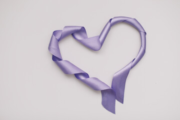 Heart shape made of ribbon on white background. Valentines and 8 March Mother Women's Day concept