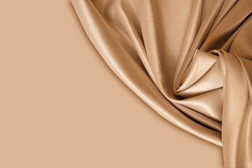Photography of beautiful elegant wavy beige / light brown satin silk luxury cloth fabric texture...