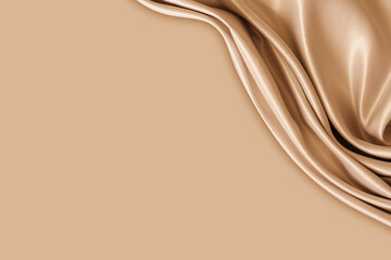 Photography of beautiful elegant wavy beige / light brown satin silk luxury cloth fabric texture with monochrome background design. Copy space. Card or banner