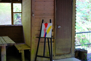 A house in the forest and a painting in progress