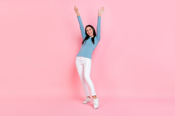 Photo of sweet cute adorable lady dressed blue shirt dancing rising arms isolated pink color background