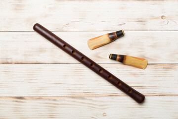 Armenian national musical instrument duduk on wooden background. Top view