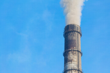 The pipe of an industrial plant emit a huge amount of toxic smoke into the air, polluting the environment. Ecological problems. Air, industrial pollution.	