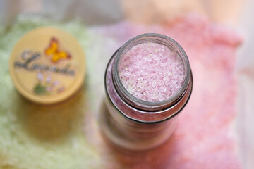 Homemade bath salt. Light purple grains in a glass jar. Top view. Concept organic beauty, handmade cosmetics