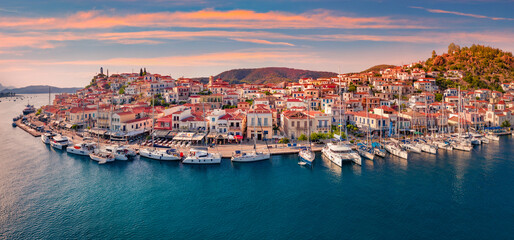Fantastic sunset in Poros town. Picturesque summer seascape of Myrtoan Sea with a lots of yachts....