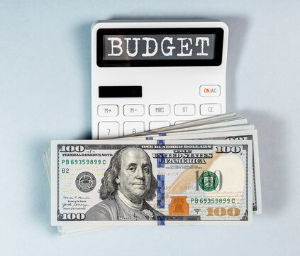 Budget word on calculator with dollars money. Photo