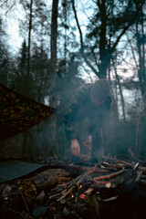 Men starting a campfire to get warm after hiking trail