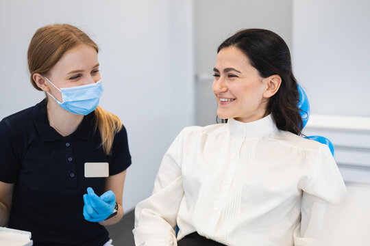 Two Women Dentist And Patient Having Fun Talking