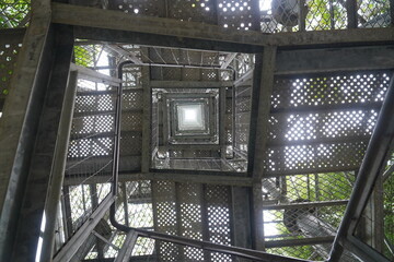 Square staircase with metal steps leading to a 42 m high observation tower. Geometric background,...
