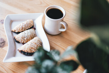 Coffee and scone on table green light 